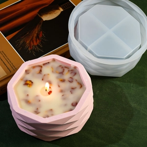Macro shot of hexagon geometric silicone mold and finished floral scented candle jar