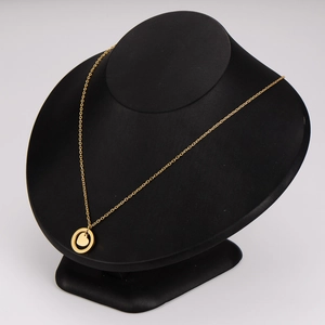 Minimalist gold stainless steel necklace with circle and heart pendant on mannequin