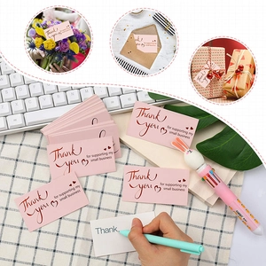 Pink Thank You stickers for small business packaging on checkered desk background