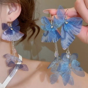 Detail of long fringe earrings with gradient blue tulle butterflies and crystal drops
