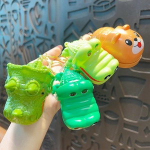 Green crocodile and dinosaur head keychains set with golden metal rings and chains