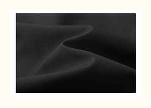 Macro shot of high-quality black woven fabric texture with smooth drape and fine weave