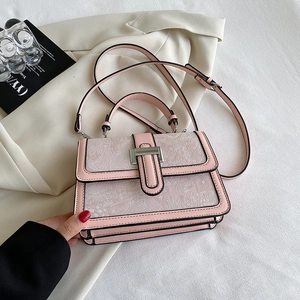 Detailed view of pink floral handbag with silver buckle and black edge finishing