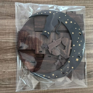 DIY boho wooden moon shelf kit in packaging including cat decor and brown wood parts
