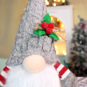 Close-up of a Christmas gnome featuring a grey knitted hat and soft plush beard detail