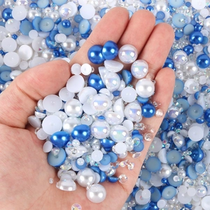 Macro shot of mixed blue and white flatback pearls and resin rhinestones for DIY nail art