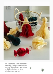 Detail view of retro honeycomb paper Christmas ornaments in red, green and cream colors