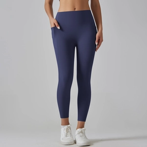 Close-up of high-waisted yoga pants with side pockets in deep blue matte fabric