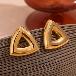 Macro shot of minimalist 18K gold plated stainless steel hollow triangle stud earrings