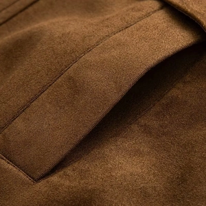 Detailed macro view of the side pocket stitching and soft brown faux suede texture