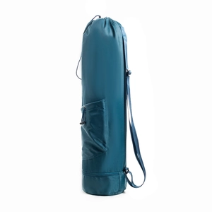 Detail view of a navy blue yoga mat bag with adjustable strap and front zipper pocket