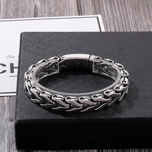 Macro detail of 316L stainless steel punk keel chain bracelet with industrial clasp