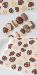 Macro shot of 3D embossed bear nail art stickers with brown grid patterns on model M-181