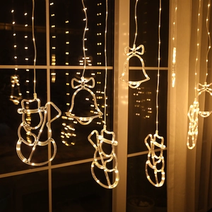 Warm white LED curtain lights featuring decorative snowman and bell shapes for Christmas decor