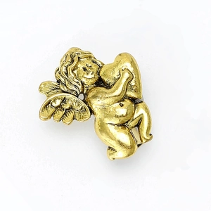 Detailed close-up of a vintage golden alloy angel brooch featuring wings and Cupid design