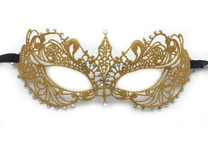 Close-up of gold lace masquerade mask with sparkling rhinestones and black satin ribbons