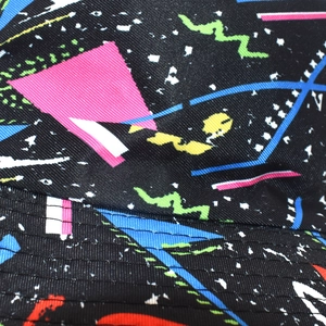 Macro detail of bucket hat showing street graffiti pattern and precision stitching on fabric