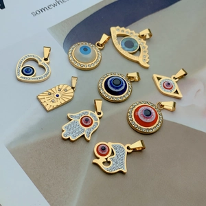 9-piece set of gold stainless steel Evil Eye and Hamsa Hand charms with enamel details