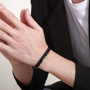 Close-up of model wearing black leather and stainless steel mesh bracelet with magnetic buckle