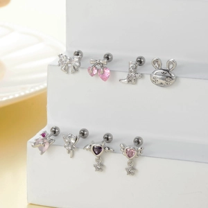 Assorted stainless steel cartilage studs with zircon bow and heart charms on white steps