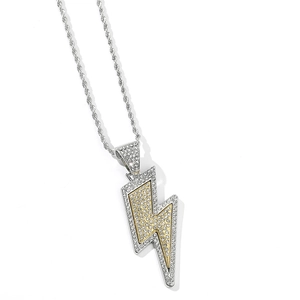 Detailed close-up of a silver twisted chain necklace with a gold-tone iced-out lightning bolt pendant