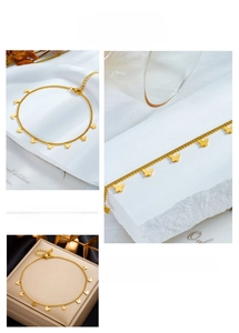 Detailed close-up of gold butterfly charms on a stainless steel chain with lobster clasp
