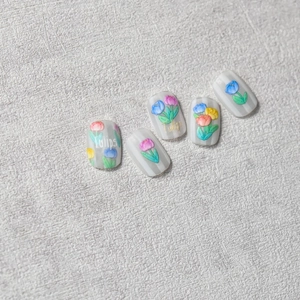 Embossed tulip nail art stickers with 3D floral designs on grey striped square nails