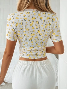 Rear view of a white Y2K floral lace short sleeve crop top with ribbed texture