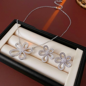 Vue macro d'une parure de bijoux florale en argent avec zircon brillant sur collier et boucles