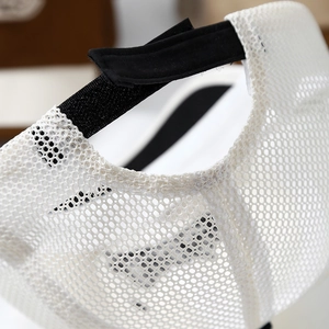 Detail of breathable white mesh fabric and adjustable velcro strap on toddler baseball cap