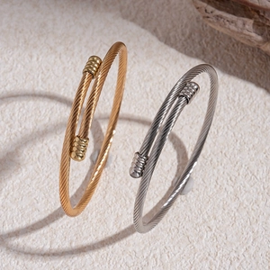 Minimalist braided stainless steel open bangle in gold and silver finish with metal caps