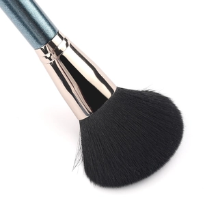 Blue handle makeup brush with black bristles and gold metal ferrule on white background