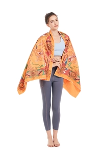 Microfiber beach towel detail showing orange mandala print used as a yoga shawl wrap
