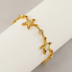 Gold stainless steel star bracelet with shimmering shell inlay and cubic zirconia stones