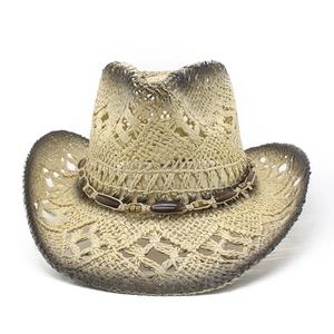 Detailed close-up of straw cowboy hat featuring woven hollow details and beaded band
