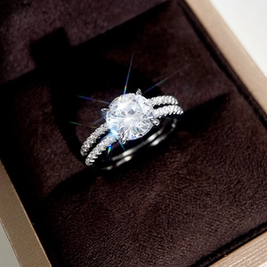 Macro detail of a classic round-cut solitaire diamond ring set in a velvet jewelry box