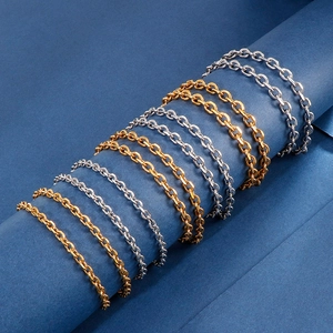 Detailed view of multiple minimalist gold and silver stainless steel O-link chains