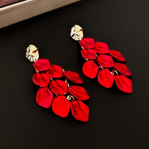 Macro detail of layered red acrylic flower petal tassels and golden metal studs