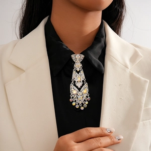 Close-up of silver geometric镂空 necktie brooch with colorful rhinestones and fringe