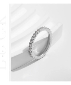 Detailed view of silver eternity ring with full moissanite pavé on a wavy pedestal
