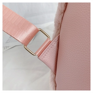Detail of pink PU leather texture with plush trim and golden metal strap hook
