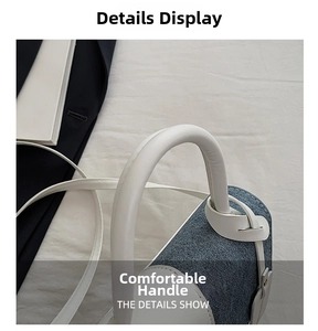 Detail view of the thick cylindrical white handle on the denim blue patchwork handbag