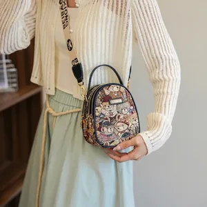 Mini floral bear print crossbody bag with wide logo strap and elegant metal plaque