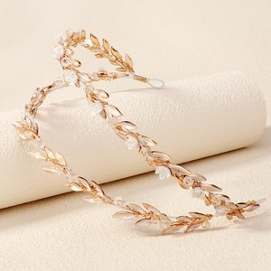 Detailed view of handmade baroque gold wire headband with leaf rhinestones and pearls