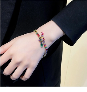 Close-up of luxury gold-plated snake bracelet with colorful zirconia stones