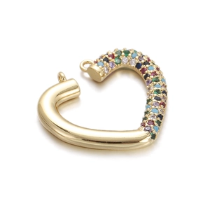 Macro detail of a gold-plated heart pendant with colorful zircon stones and rings
