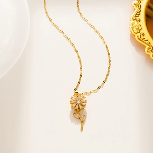 Detailed view of rotating sunflower necklace in gold finish with sparkling zircons