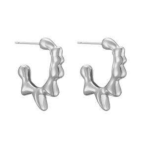 Detail view of irregular molten lava heart stud earrings with a silver metallic finish