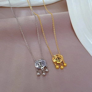 Titanium steel Fu character lock necklaces in gold and silver with bell pendants