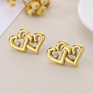 Detailed macro shot of 18K gold plated interlocking heart earrings with cubic zirconia stones